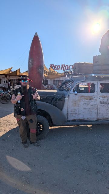 Grandpa by the war car with the Red Rocket gleaming behind.